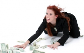 Crazed Business Woman Grabbing Money From Floor.  Very funny expression on model's face. Shot in studio over white.